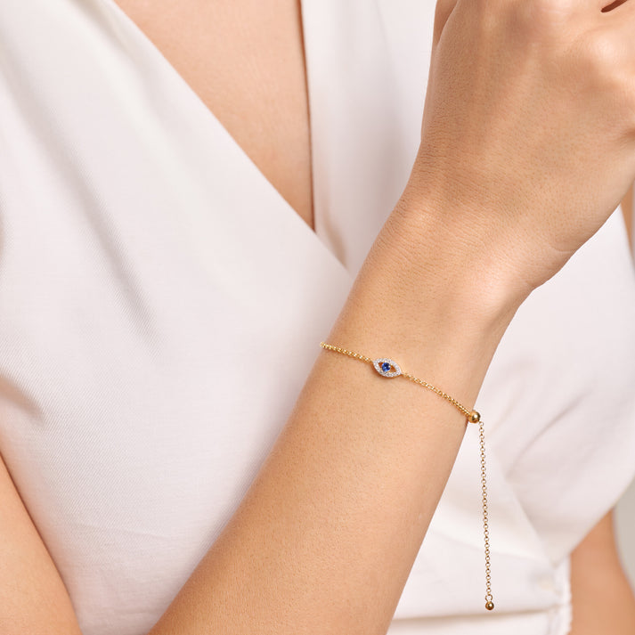 Gold bracelet with an evil eye charm in lab diamonds on model