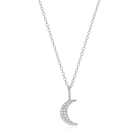 Silver crescent moon necklace with small diamonds on a white background