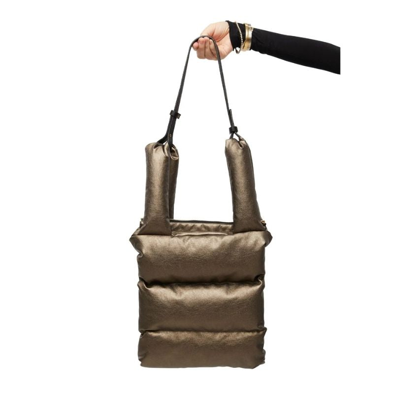 Vegan leather puffer tote in bronxw with a inside pocket and top zip closure . Made in Canada