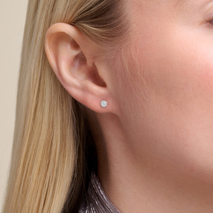 Model is wearing a pair of cluster lab diamond stud earrings set in silver 
