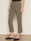 Person wearing leopard print pants against a plain background