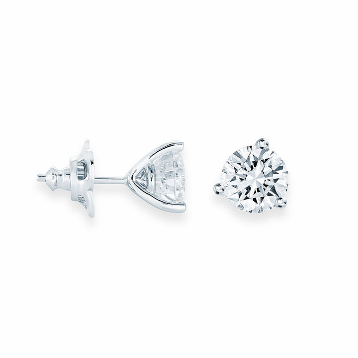 Two diamond earrings on a white background