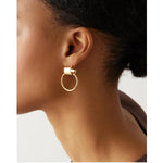 Faye knockers gold earrings on model