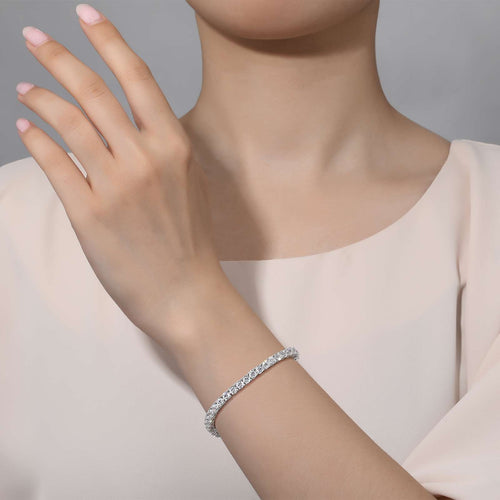 Model wears 6.5 CTW Tennis bracelet by Lafonn set in white metals highlighting the  59 Simulated Diamonds. 