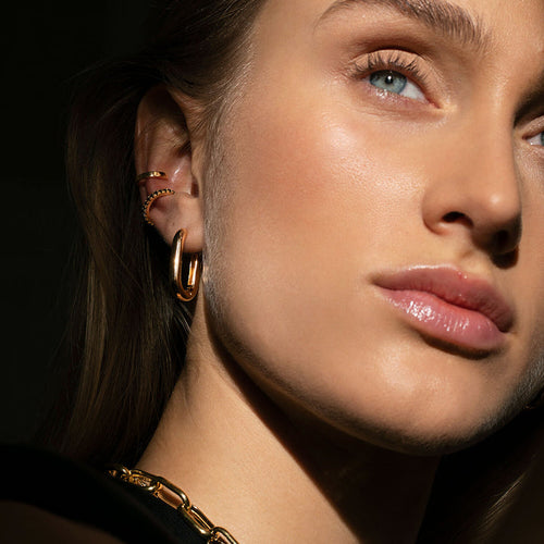 Model wearing 18k gold plated Capri Medio Pianura Earrings by Sif Jakobs at Hickox Jewelers & Lifestyle