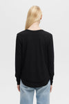 Model wearing Ava long sleeve top in black with hemline detail- Vack view 