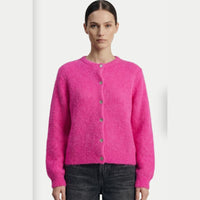 A neon Pink crewneck cardigan knitted in Alpaca yarn on a model.