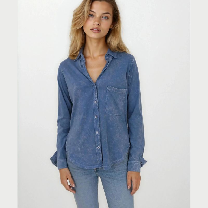 Woman wearing a Pima cotton long-sleeve denim blue shirt and jeans on a white background
