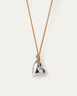 Front view of Large Silver heart on a cord by jenny Bird 