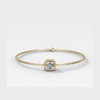A delicate gold chain bracelet featuring a central square bezel-set diamond, displayed on a clean light gray background.
