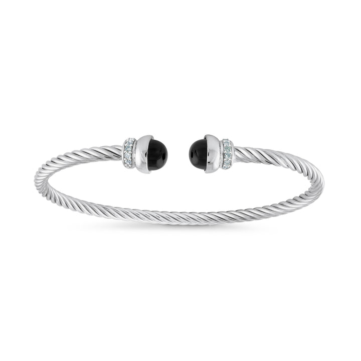 A silver cable-wrapped cuff bracelet with two black oval onyx stones, each accented by a small halo of clear pavé stones, shown on a plain white background.