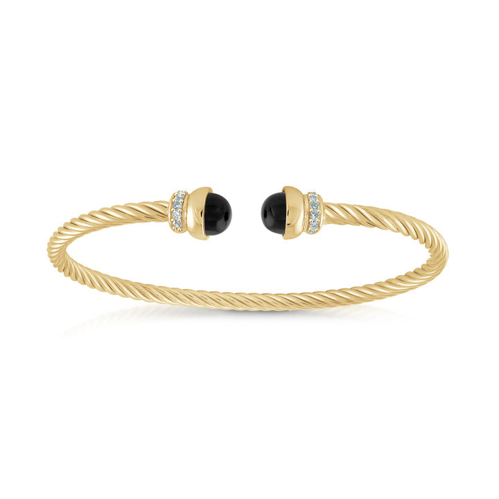 A twisted yellow gold cable bangle bracelet with black onyx stone end caps, each accented with a small row of clear pavé-set stones, shown on a clean white background.