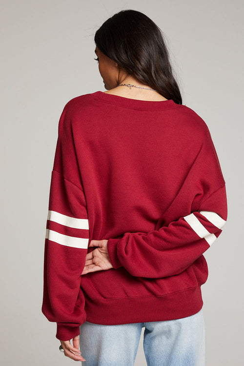 Back view - Physical Education Casbah Pullover in red with white writing and stripes on sleeves 