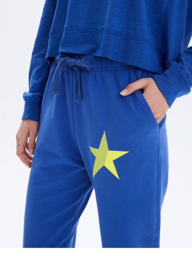 Close up of graphic yellow neon star French Terry P.E Sweatpants in Electric blue By CHRLDR - Hickox Jewelers & Lifestyle 