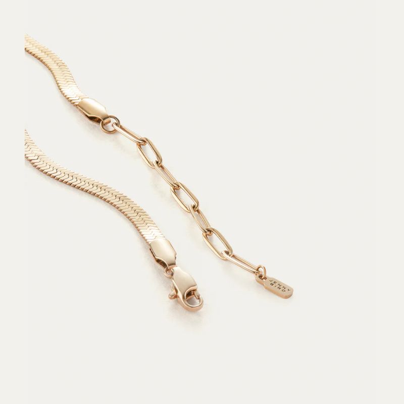 Gold Plated Snake chain anklets on a light beige background