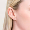 Close-up of a model wearing a Sterling silver and lab diamonds Crescent moon-shaped stud earring .l 