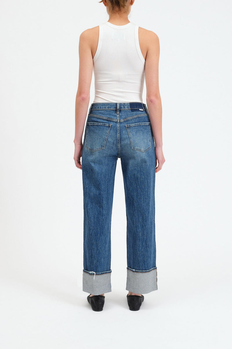 EASTSIDE is a Cuffed denim jean in RISHHOUR  - a slightly distressed vintage indigo wash-, beltloops, and 5 pocket style shown here in this back view.