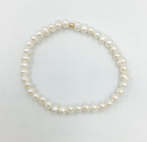 Bracelet with 4mmWhite Freshwater Pearls strung on a stretchy elastic  making it easy to take on and off. 