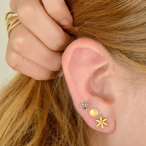 Model wearing Handcrafted gold round Delicate Hammered Stud earring   by Anne Sportun 