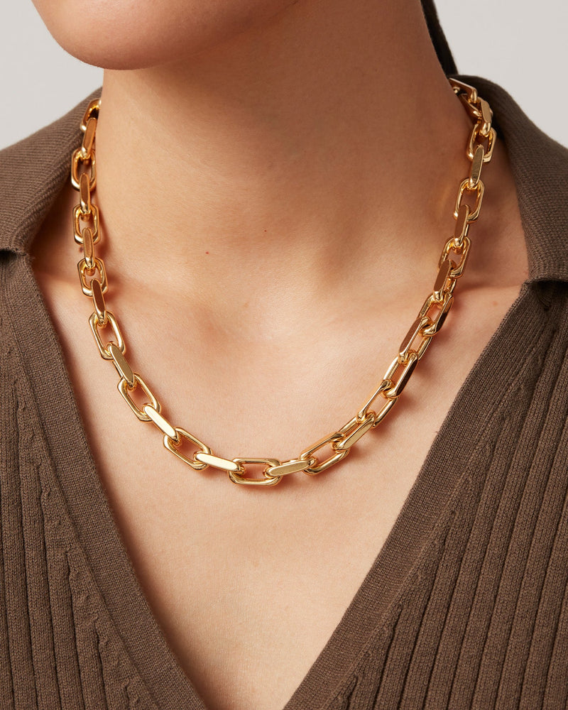 The Model is wearing the Loire faceted cable link chain necklace, which is Made of gold-dipped brass with a high-polish finish.

