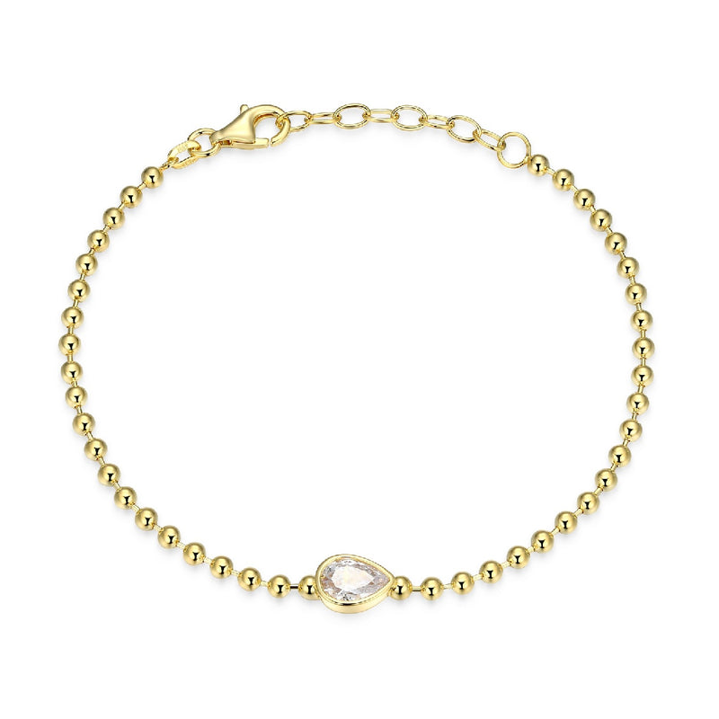 Gold bracelet with a pear bezel set CZ on a white background