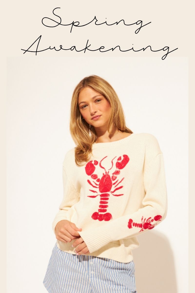 Woman wearing a white sweater with red lobster design, text 'Spring Awakening' above.