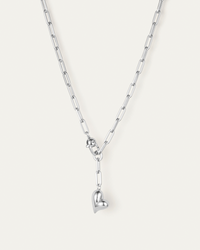 Silver chain necklace with a heart pendant on a white background
