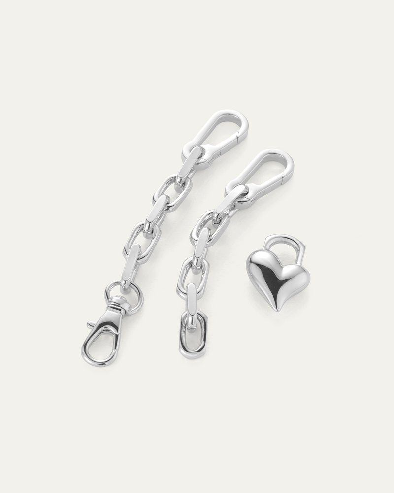 Flat full view of silver link bracelet with removable large heart charm 