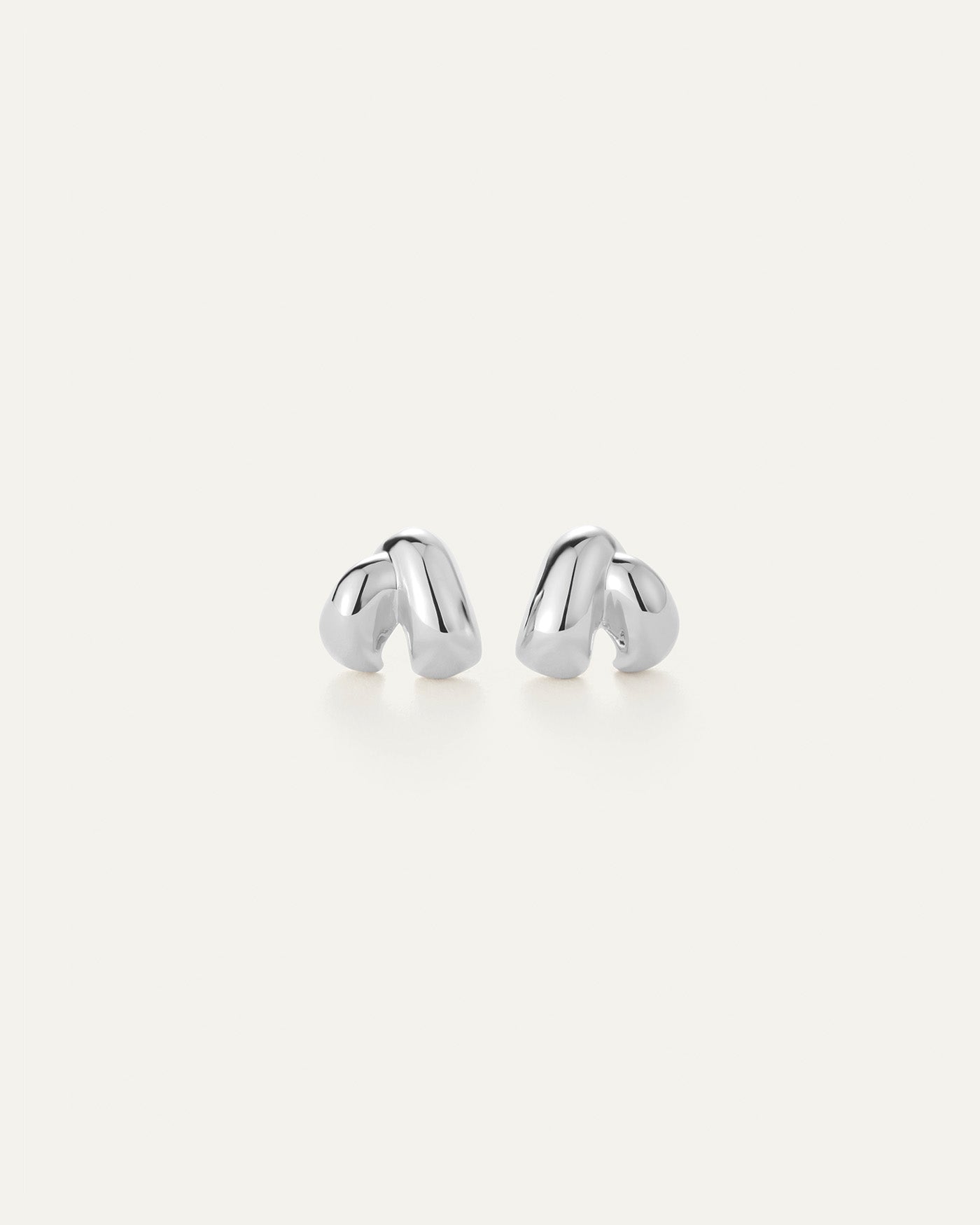 Pair of silver earrings on a white background