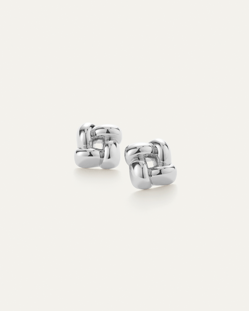 Pair of silver hoop earrings on a white background