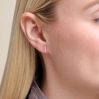 Close-up of a model wearing Lab diamond bar earrings set in rhodium plated sterling silver 