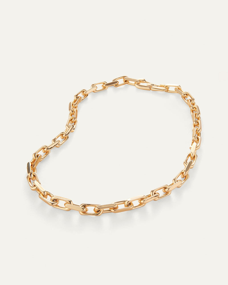 This necklace is made of gold-dipped brass. It has a high-polish finish, a faceted cable link chain, and a foldover clasp. The necklace is 18.8 inches long.