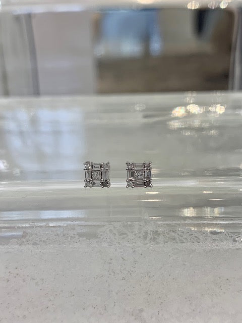 Diamond earrings set with Round, Baguette, and princess cut stones.