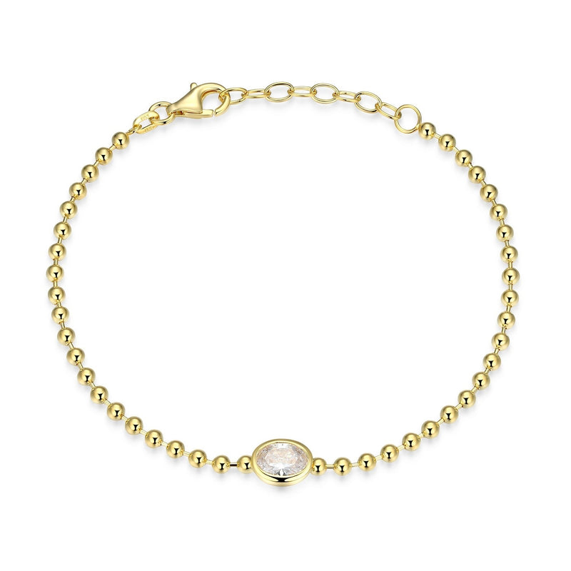 Gold bracelet with a central gemstone on a white background