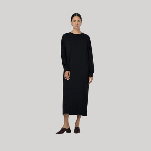 A Black longer length dress with pockets, a crewneck and long sleeves in a soft Modal Fabric  by Paper Label. 