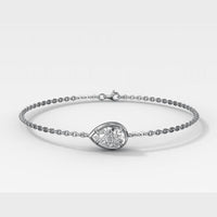 A silver chain bracelet featuring a teardrop-shaped clear gemstone in a polished bezel setting, displayed on a clean light gray background.