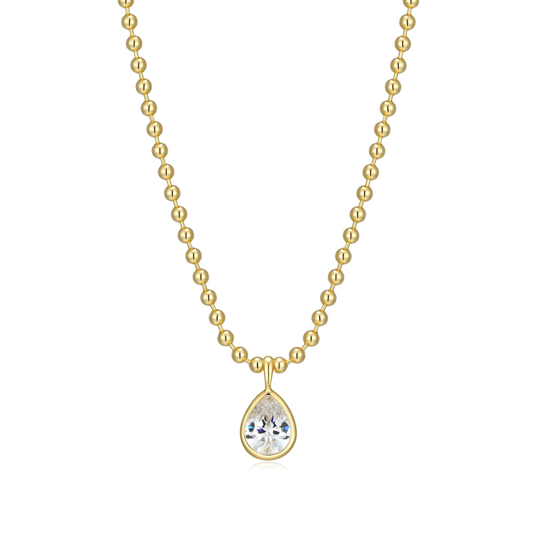 Gold bead ball necklace with a -pear cut bezel set Cubic Zirconia pendant on a white background 