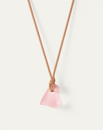 Jenny Bird large pink Glass Heart hanging on a sand colored cord. full view 