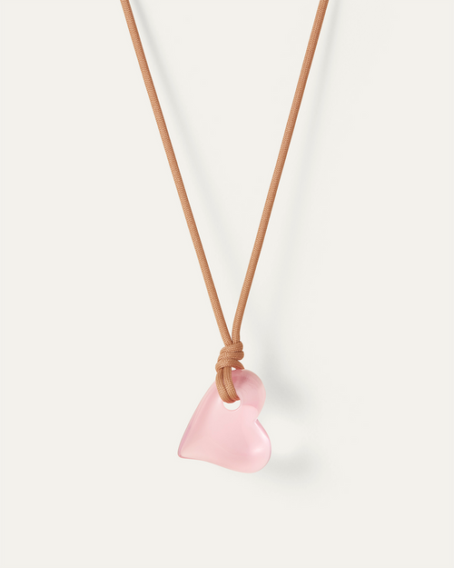 Jenny Bird large pink Glass Heart hanging on a sand colored cord. full view 