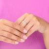 Delicate sterling silver band with an open heart outlined in Lab diamonds on model . 