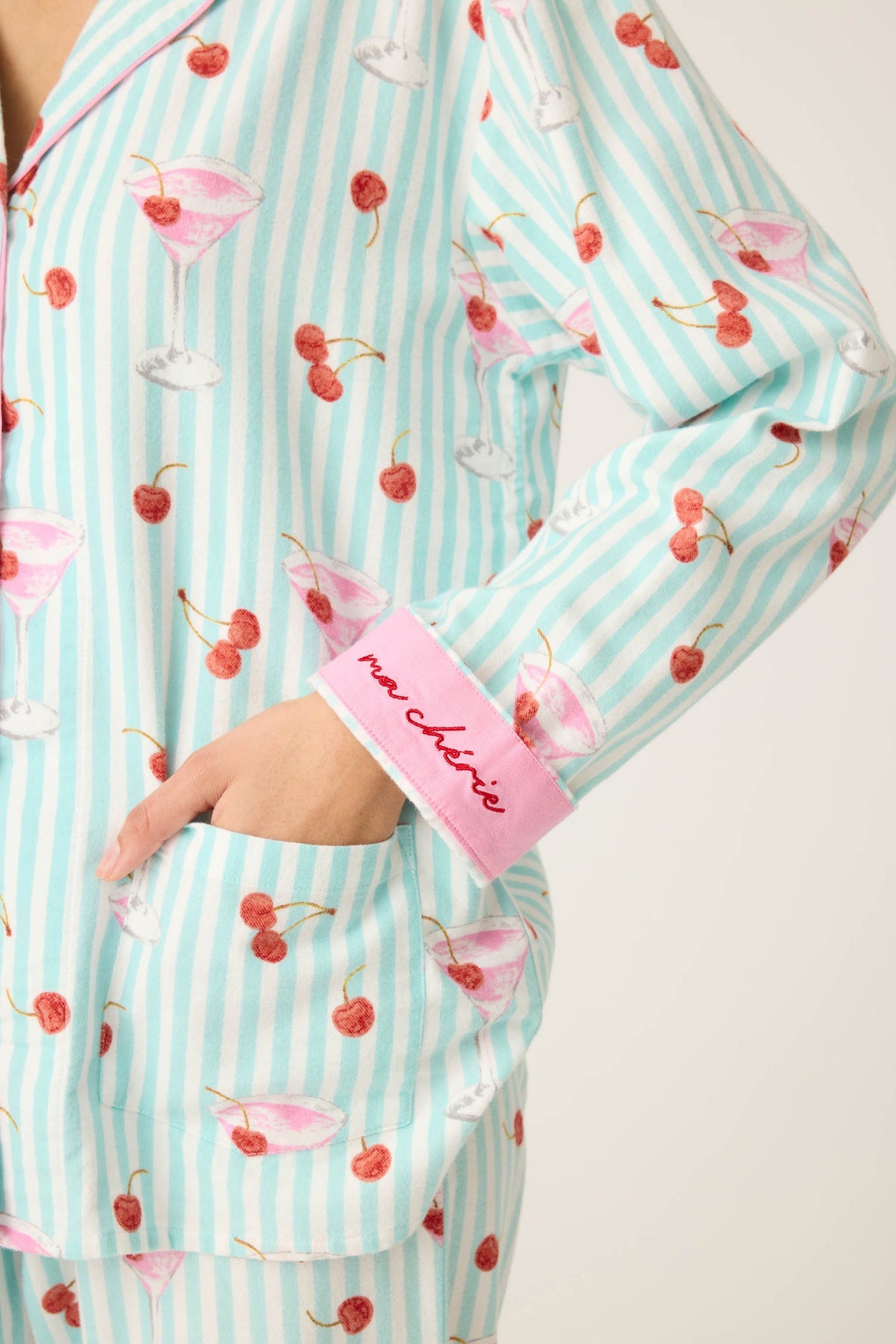 Close up of the Flannel cotton pajama print with  Patterned with minty stripes, pink cocktails, and cheery little cherries