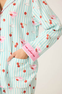 Close up of the Flannel cotton pajama print with  Patterned with minty stripes, pink cocktails, and cheery little cherries