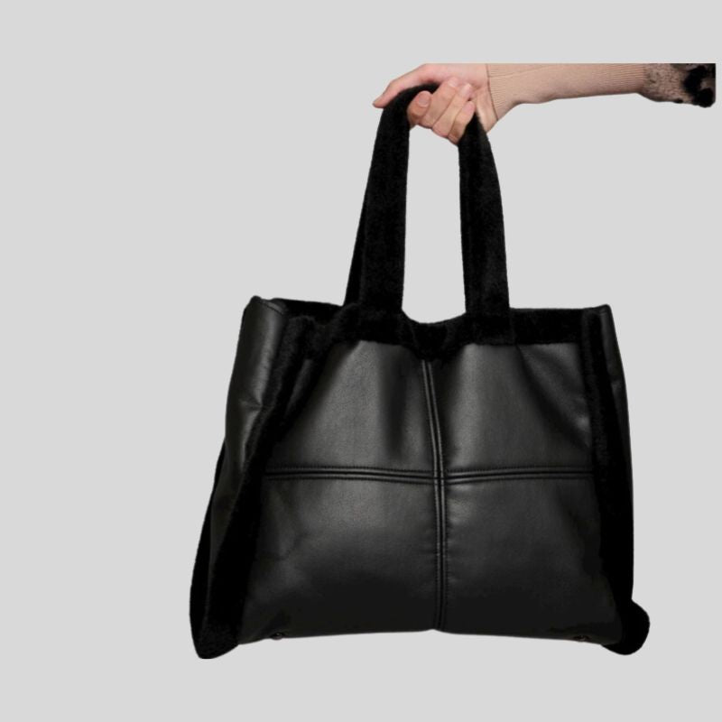 A large size Vegan Black Leather & Faux Fir Sheepskin Tote. features - outside pockets and a top snap closure 