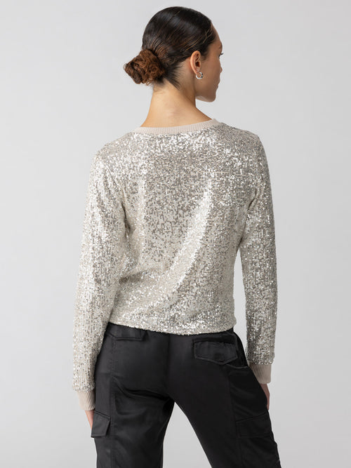 back of Sanctuary's sparkle together long sleeve top in champagne sequins. 