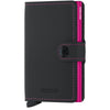 Miniwallet outsideis matte black leather with a fuchsia leather interior 