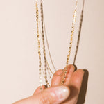 Close up view of Leah Alexandra~ Shimmer  3 layer Necklace - ckearubg ahowubg the 3 strands of  10k  Gold