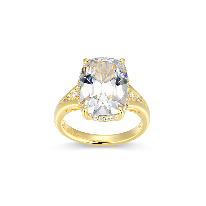 Gold ring with a large clear gemstone on a white background