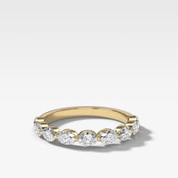 A yellow gold eternity ring featuring five round brilliant-cut lab diamonds set in a row (east west), shown on a clean white background with a soft shadow.