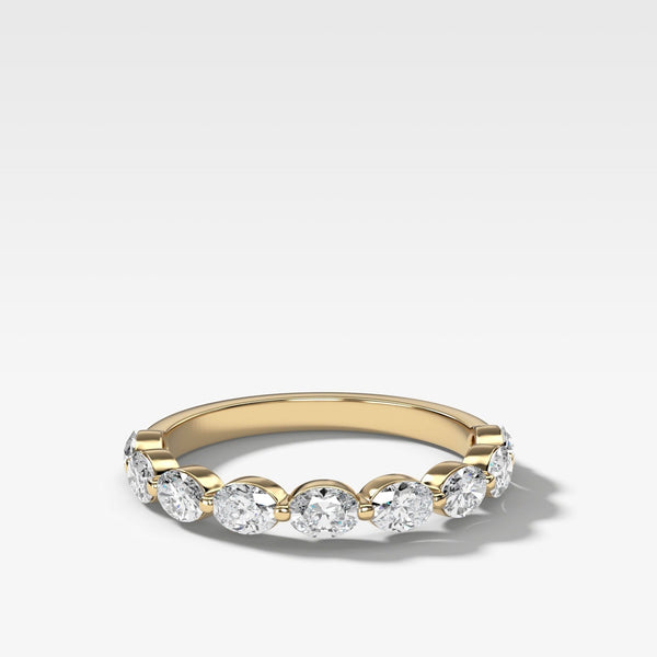 A yellow gold eternity ring featuring five round brilliant-cut lab diamonds set in a row (east west), shown on a clean white background with a soft shadow.