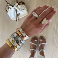 Model wearing a stack of Square Aura Bracelets 